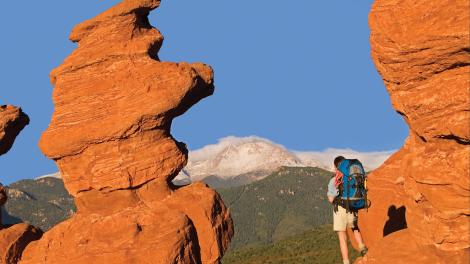 Hiker at Siamese Twins rock formation at Garden of the Gods, Colorado
