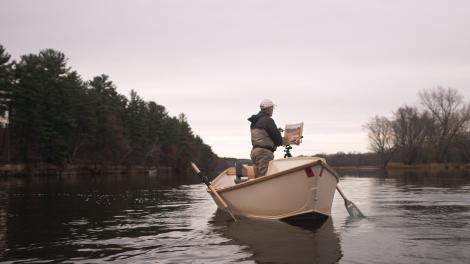 Bob White in a boat painting on the St. Croix River in Minnesota Bob White in a boat painting on the St. Croix River in Minnesota
