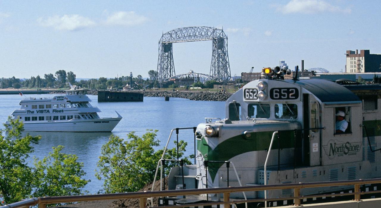 A North Shore train slips by the Vista Star craft A North Shore train slips by the Vista Star craft