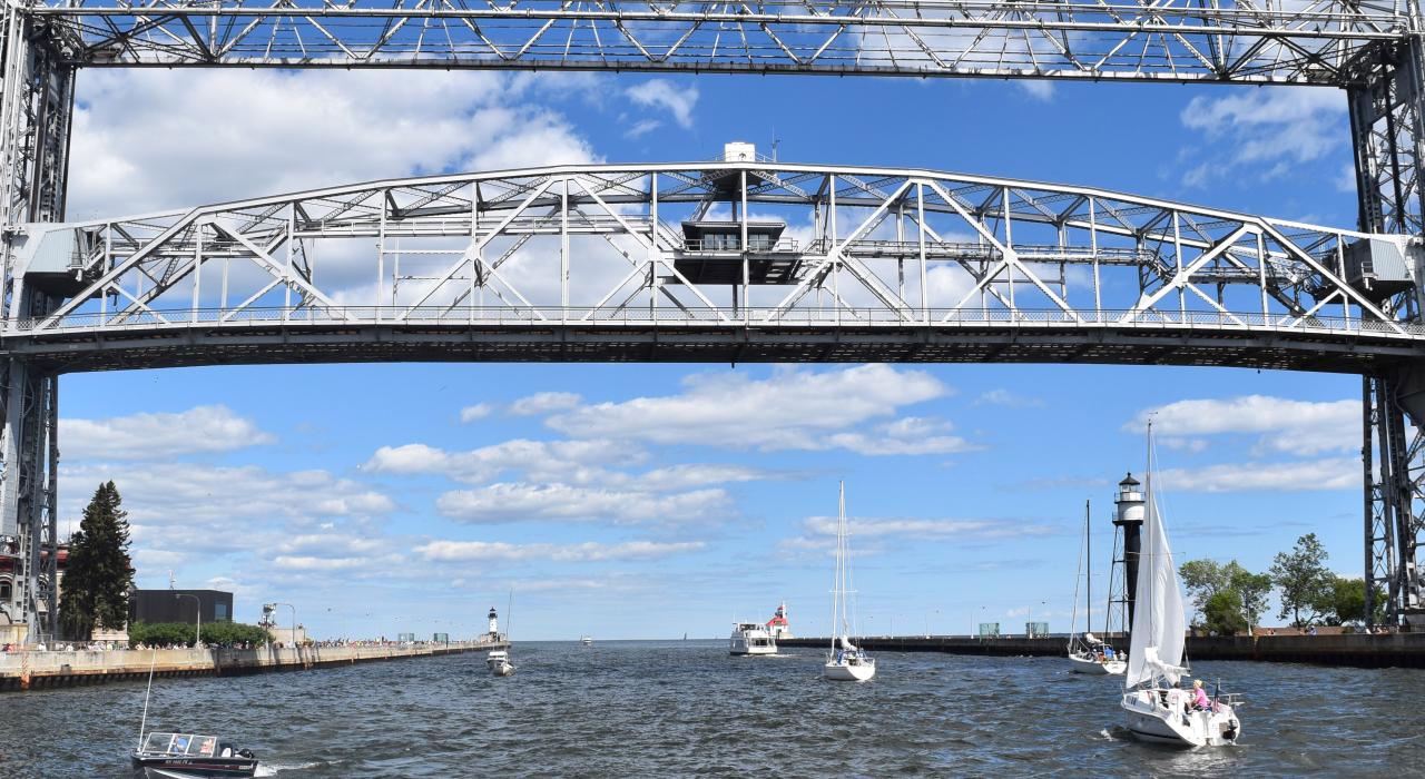 Sailboats pass underneath the Aerial Lift Bridge Sailboats pass underneath the Aerial Lift Bridge