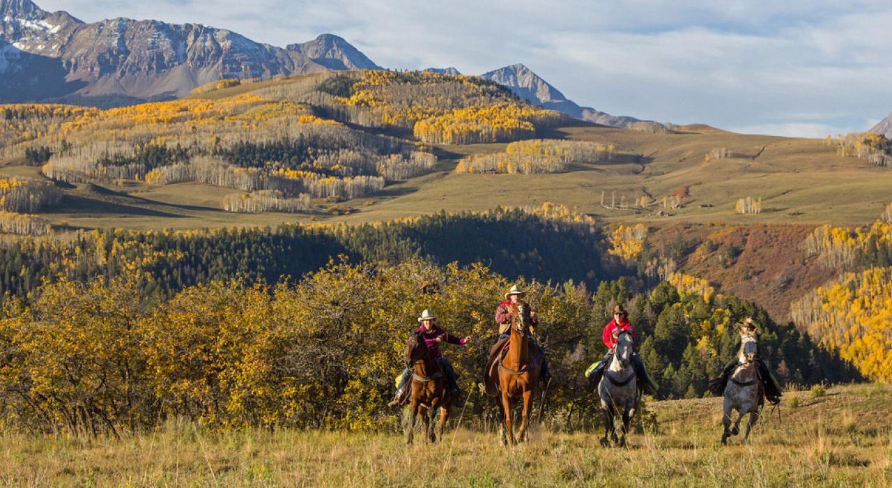 Horseback riding through rugged mountain terrain