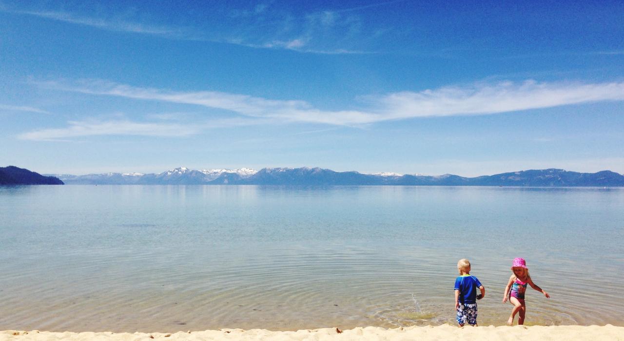 Children exploring the shore of Lake Tahoe near Carson City