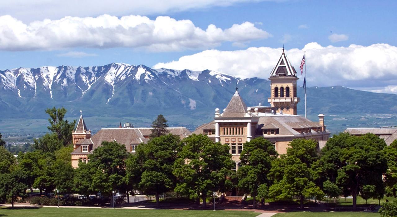 The Old Main Building at Utah State University with a snow-capped mountain backdrop The Old Main Building at Utah State University with a snow-capped mountain backdrop