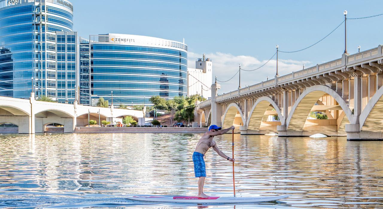 Stand-up paddleboarding under the sun on Tempe Town Lake