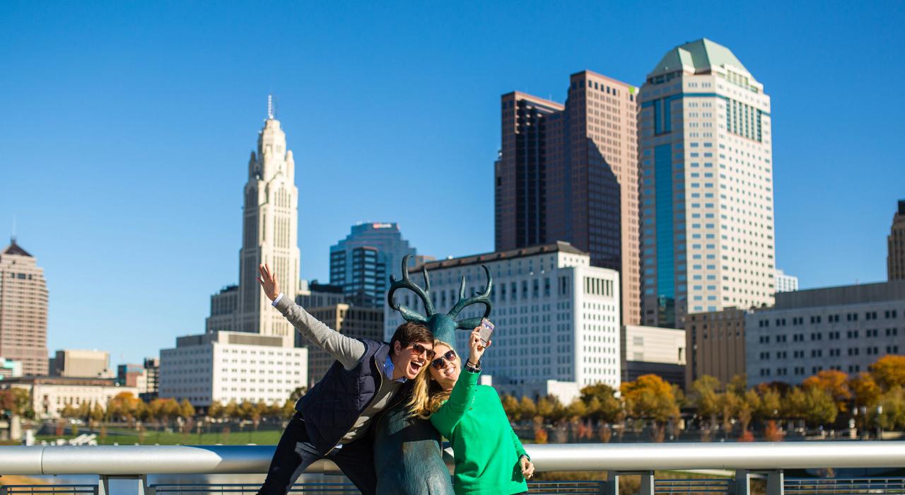 Posing with the deer sculpture in front of the city skyline on the Scioto Mile Posing with the deer sculpture in front of the city skyline on the Scioto Mile