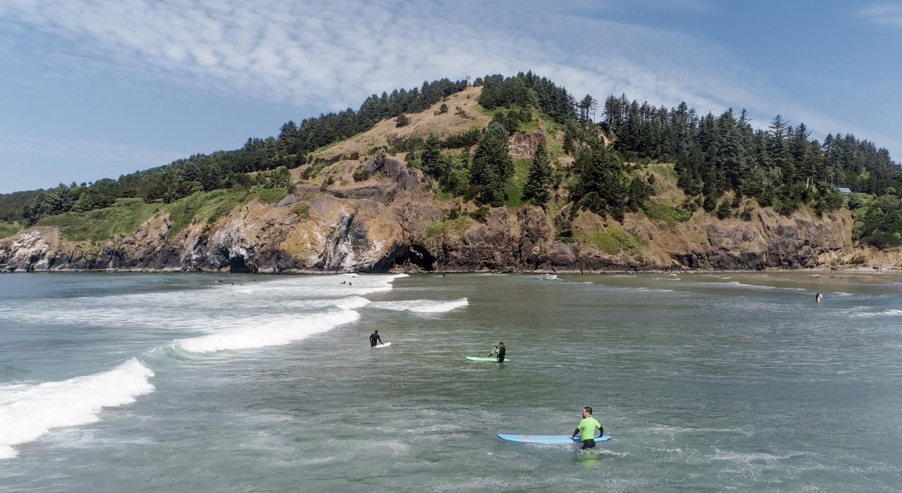 享受俄勒冈州纽波特 Agate Beach 海滩海浪的冲浪者